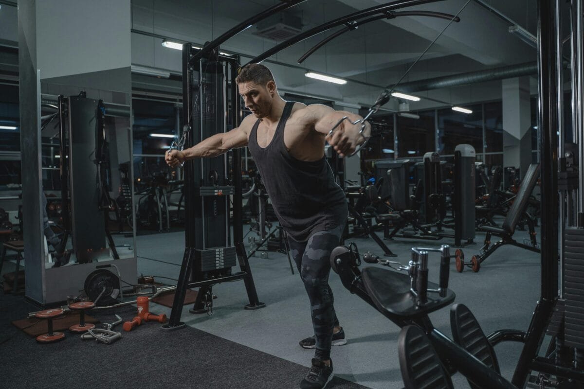 pexels-photo-5327505-5327505 Muscular man working out in the gym using a cable crossover machine.